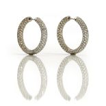 A pair of white gold and diamond earrings, each designed as a hinged hoop,