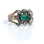 An early 19th century gold and silver set emerald and diamond cluster ring,