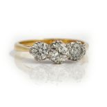 A gold and diamond set three stone ring,