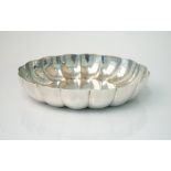 A silver shaped circular strawberry dish, decorated with lobed panels to the border,