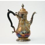 A George III silver coffee pot of baluster form having a bud finial and raised on a circular foot,