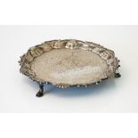 A George II silver salver, of shaped circular form, decorated with a scrolled rim,