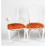 A set of twelve glossy white finish dining chairs, with pierced splats,