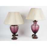 A pair of facet cut amethyst glass table lamps, with bronzed mounts and pleated shades (2).