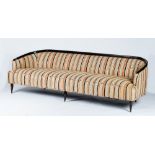 A sleek sofa, circa 1950, with curved dark stained frame,