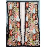 A pair of curtains, with large multicoloured wild flower pattern, with ruched black chintz trim.