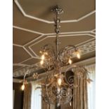 A silvered wrought metal six-light chandelier,