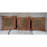 A set of three moss velvet cushions with bobble bands (3).