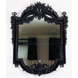 An ornate high black gloss frame mirror, in 19th century French style,