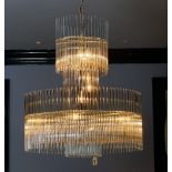 A contemporary glass and gilt metal frame chandelier, hung with tubular drops, 80cm drop.