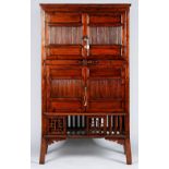 An Asian cabinet, enclosed by two pairs of doors with a compartment below enclosed by sliding doors,