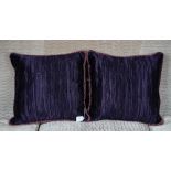 A pair of deep purple pleated silk cushions (2).