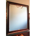 A rectangular wall mirror in 17th century style, the distressed frame with scrolling branches,