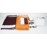 A set of matching towels, flannels and bed linen, white with dark purple trim.
