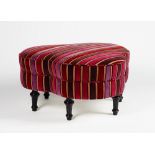 A clover-leaf shape stool, upholstered in striped velvet, on turned ebonised legs,