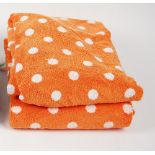 A collection of orange and white spotted towels (qty).
