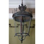 A wrought metal porch lantern, in 18th century style, with curved glass sides,