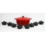 A Molten red casserole dish and eight individual Le Creuset black petit casserole dishes(9).