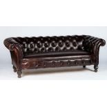 A Victorian style Chesterfield settee, button upholstered in brown leather with close nailed arms,