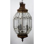 A silvered metal octagonal hanging lantern of three lights in a Moorish style, with glazed sides,