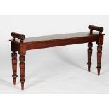 An Edwardian walnut hall bench, with roll arms, on turned legs, 101cm wide x 45cm high.