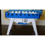 An Italian table football game, coin operated, in blue and white, 145cm wide x 89cm high.