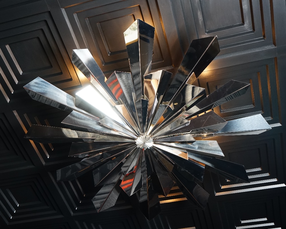 A contemporary chromium starburst light fitting, 120cm diameter.