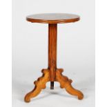 A stained pine pedestal table, 19th century, with a circular top, on a pillar and tripod base,
