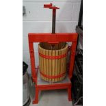 A red metal frame and wooden apple press and a Ballihoo Pressure Barrell and other items.
