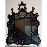 A high gloss black finish overmantel mirror, in Chinese Chippendale taste, of shaped outline,