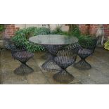 A wrought metal wirework five piece loggia suite, four chairs with scroll over backs,