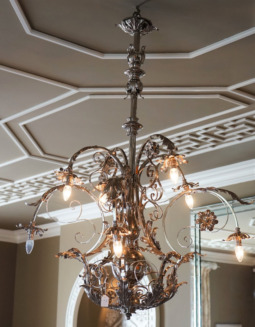 A silvered wrought metal six-light chandelier,