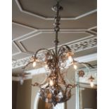 A silvered wrought metal six-light chandelier,