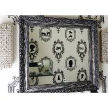 A rectangular wall mirror, in distressed moulded silvered and black painted frame,