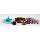 A contemporary wooden fruit bowl, amethyst glass tumblers,