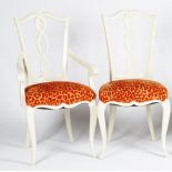 A set of twelve glossy white finish dining chairs, with pierced splats,