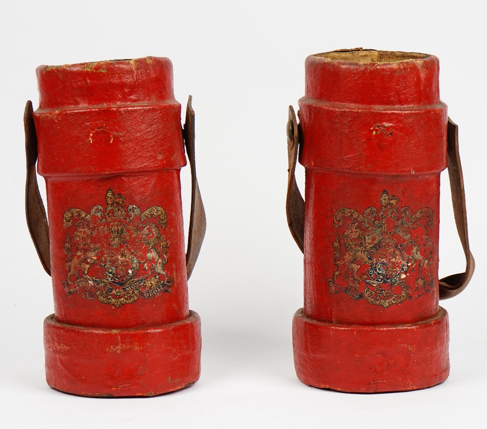 Two red painted canvas cartridge cases with leather swing handles and Royal crests, 33.