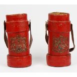 Two red painted canvas cartridge cases with leather swing handles and Royal crests, 33.