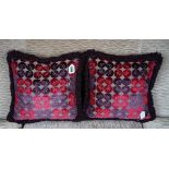 A pair of cushions in amethyst and magenta cut velvet (2).