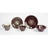 A Portuguese stoneware Meteus breakfast and dinner service with plum glaze (qty).