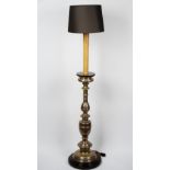 A silvered metal and wooden floor standing lamp, in 17th century Italian style,