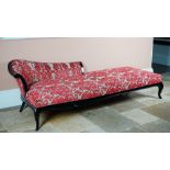 A large ebonised chaise longue, with shaped back and stuff-over seat, on cabriole legs,
