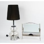 A chromium frame magazine rack with plate glass sides,