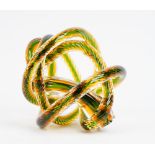 A contemporary glass sculpture of interlaced rope-twist form in clear, green and amber tint.
