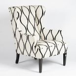 A mid century wing armchair, upholstered in ivory and black geometric linen,