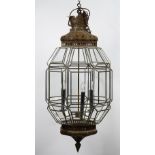 A silvered metal octagonal hanging lantern of three lights in a Moorish style, with glazed sides,