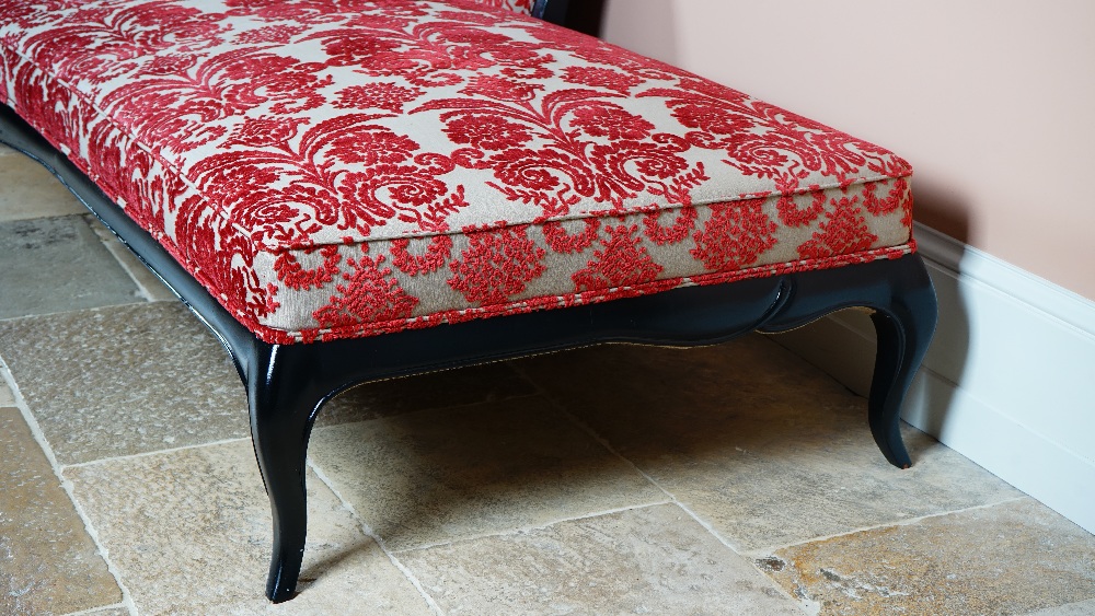 A large ebonised chaise longue, with shaped back and stuff-over seat, on cabriole legs, - Image 2 of 2