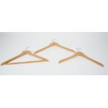 A large collection of wooden coat hangers (qty).