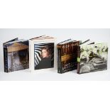 A collection of coffee table books including Wide Angle National Geographic Greatest Places and
