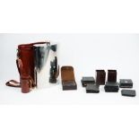 A brown leather Growler bag, containing an oversize spirits flask,